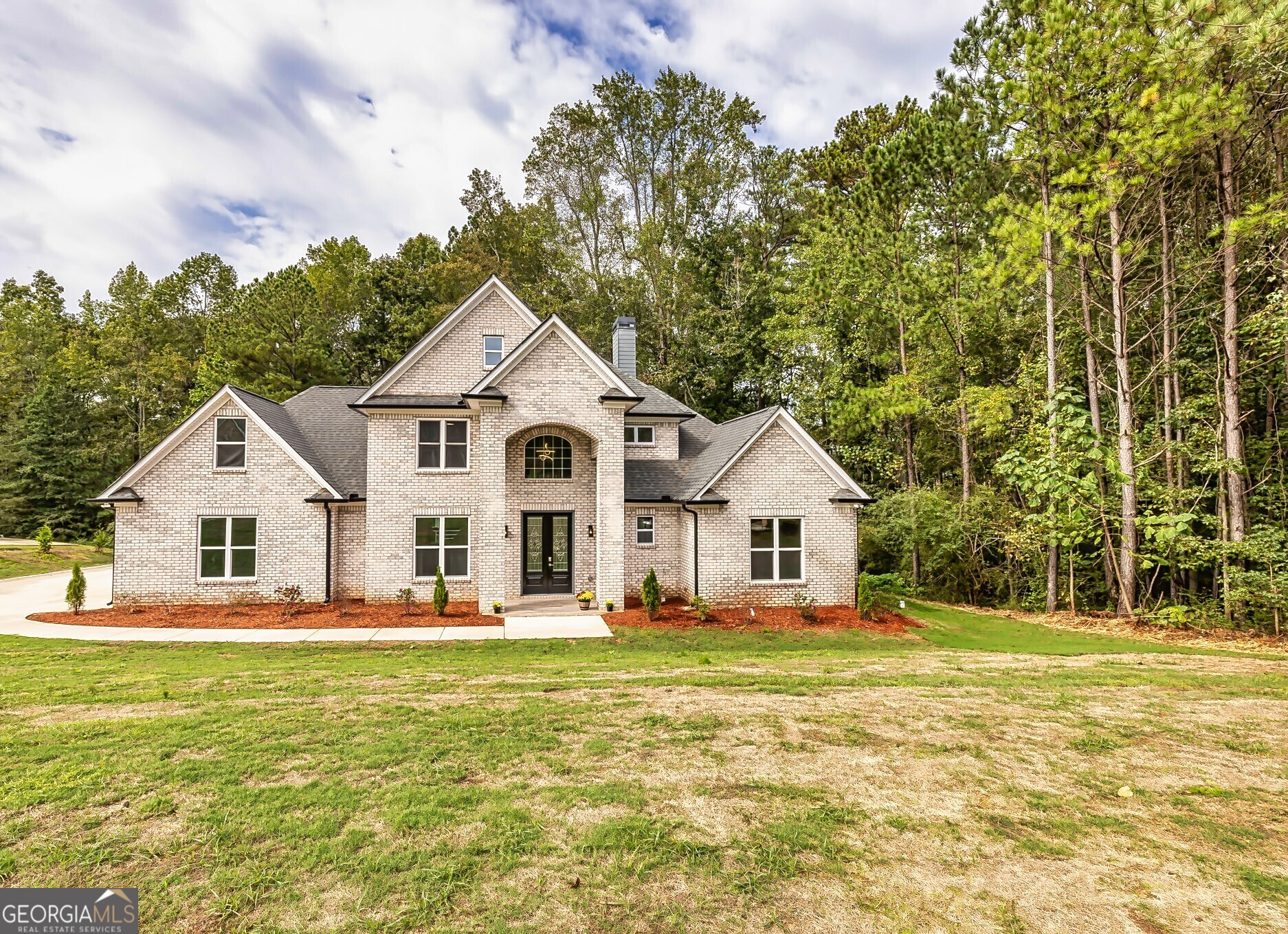 a front view of a house with a yard