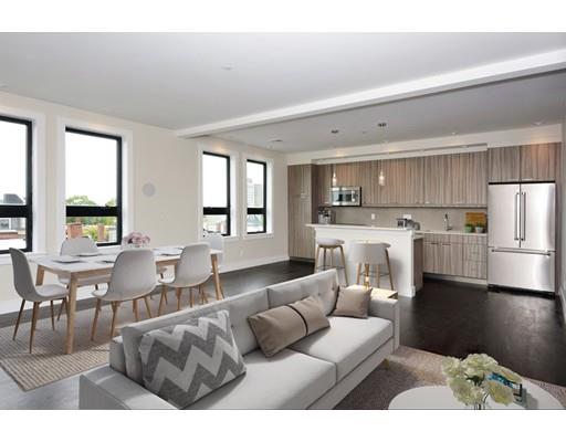 a living room with furniture and kitchen view