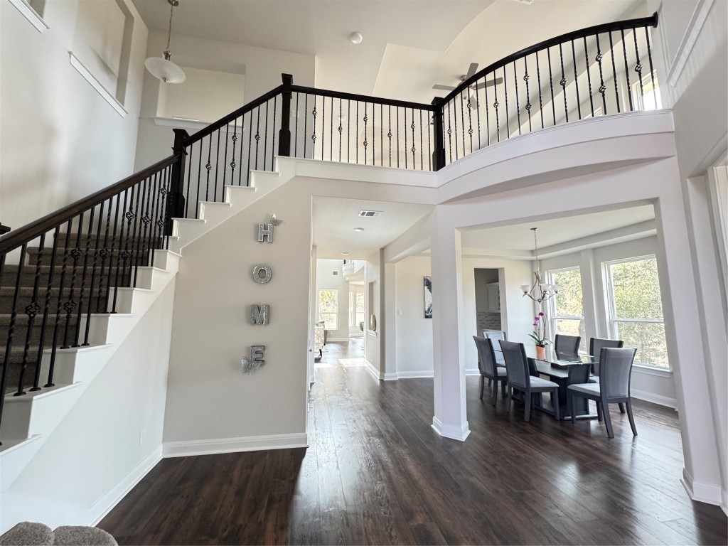 a view of an entryway wooden floor and windows