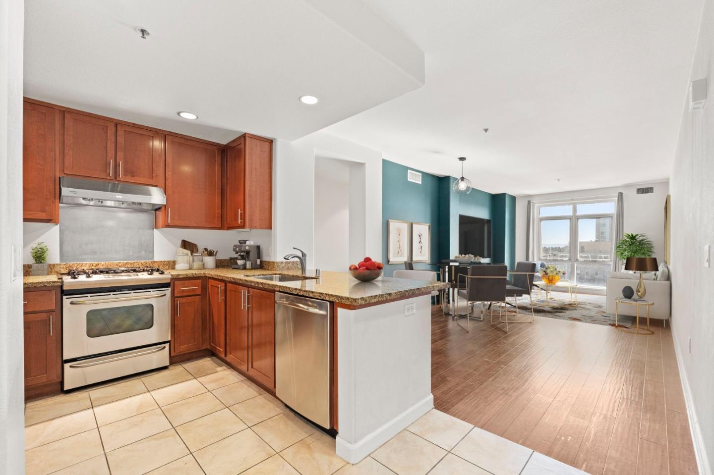 a kitchen that has a lot of cabinets in it and wooden floors