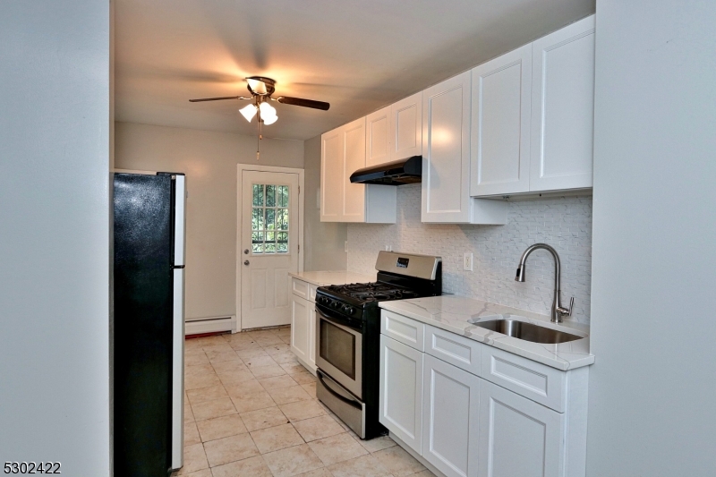 a kitchen with stainless steel appliances a sink stove and refrigerator