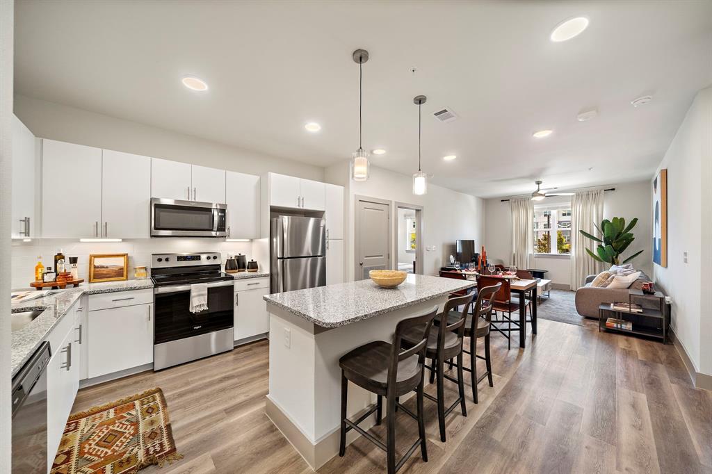 a view of a dining room with furniture kitchen and stainless steel appliances