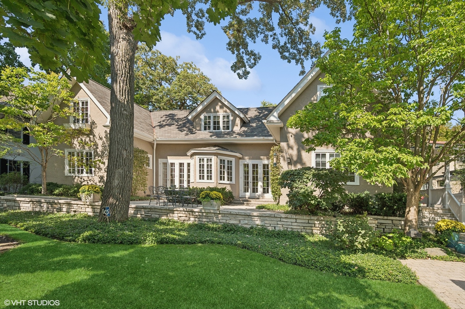 a front view of a house with a garden