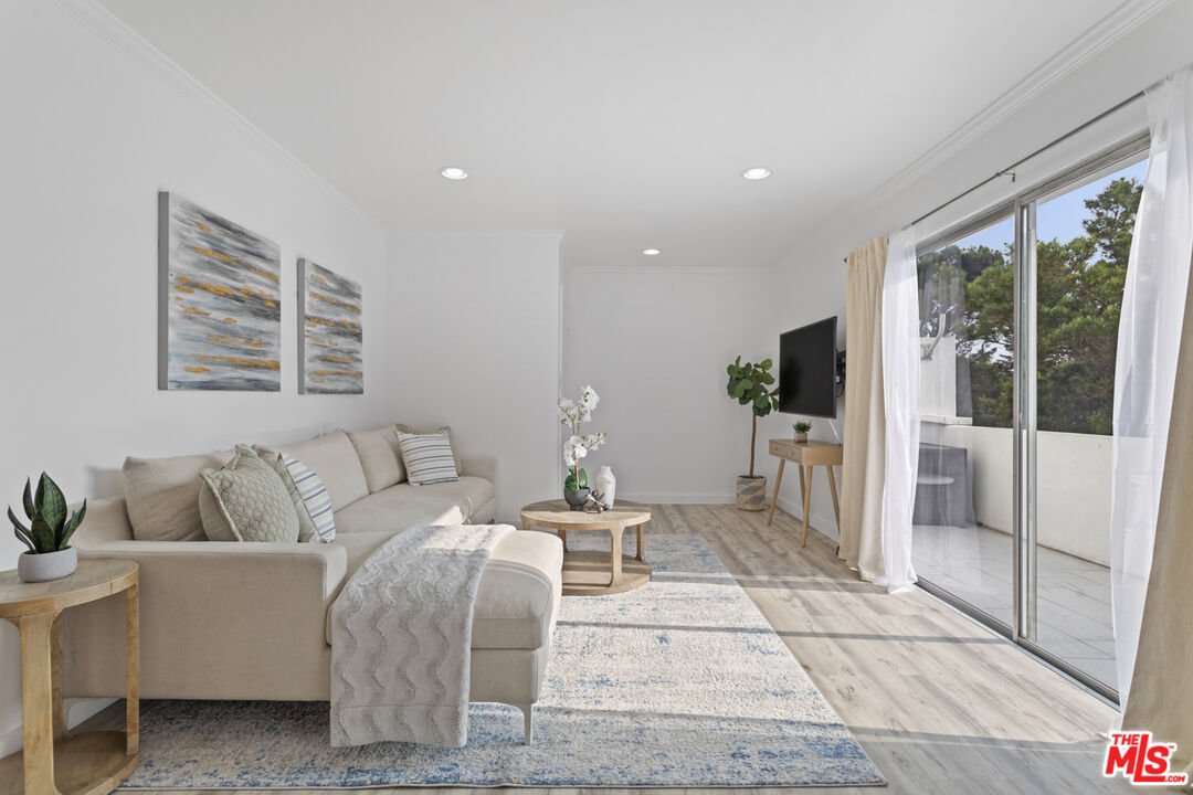 a living room with furniture a large window and table