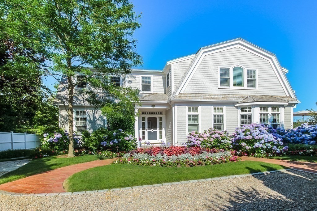 a front view of a house with a garden