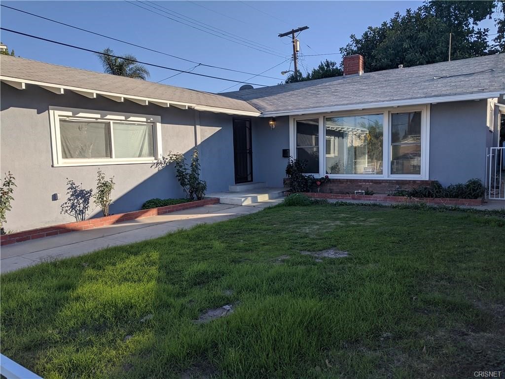 a view of a house with a yard porch and sitting area