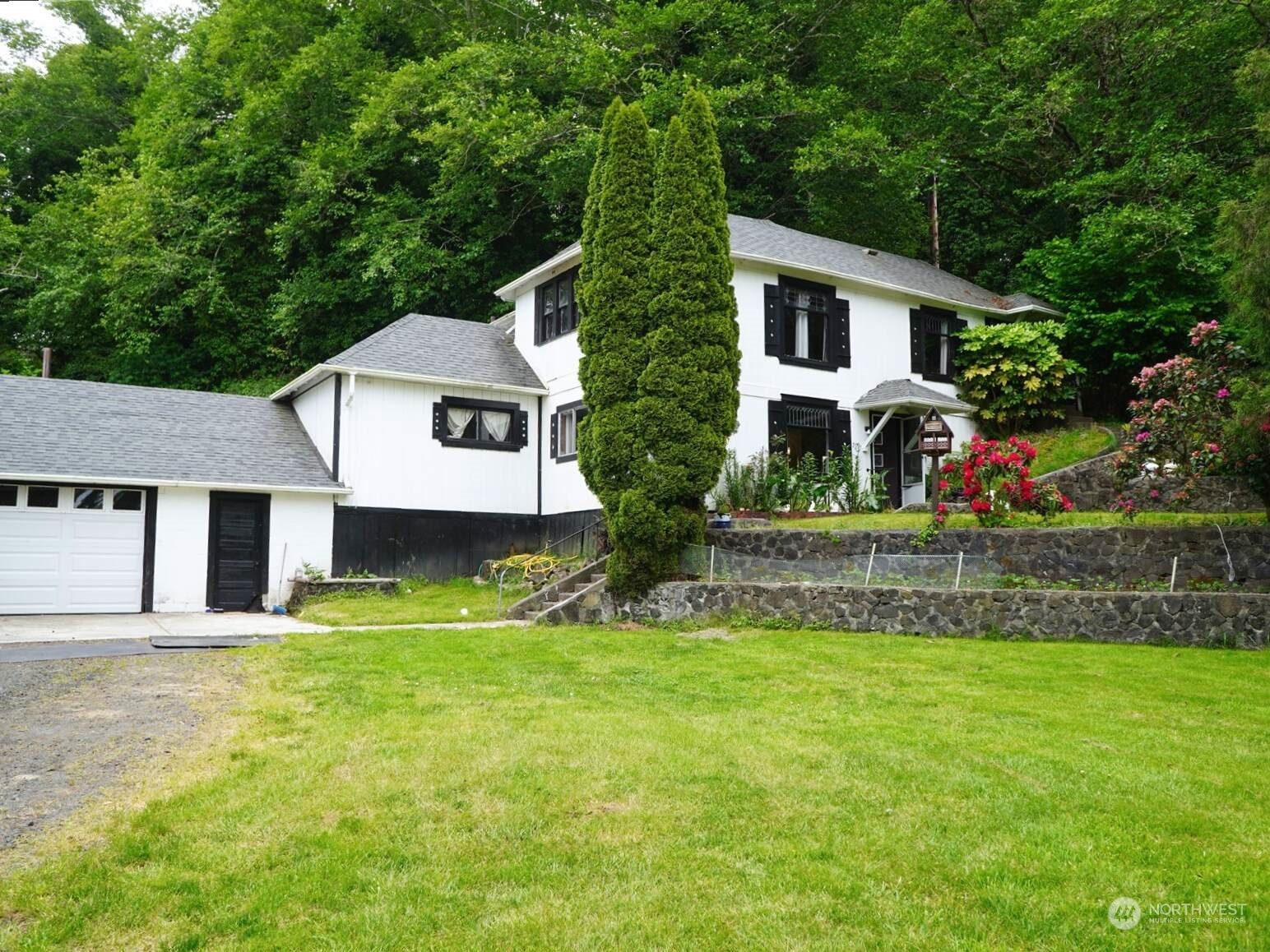 a front view of house with yard and green space