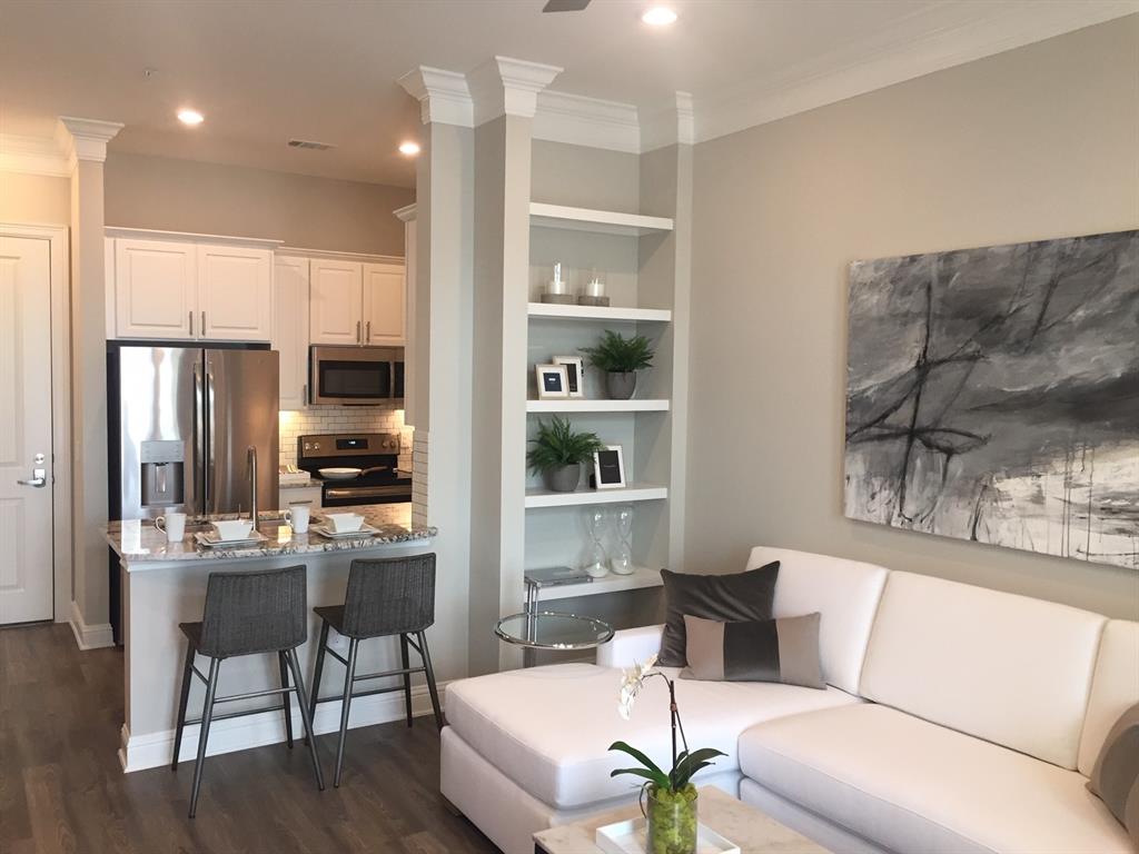 a living room with furniture and a kitchen view