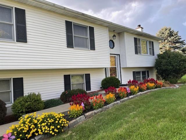 a front view of house with yard and garage