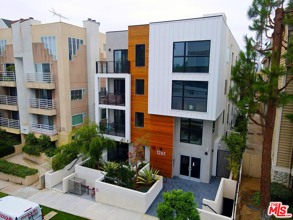 a view of a building with a garden and plants