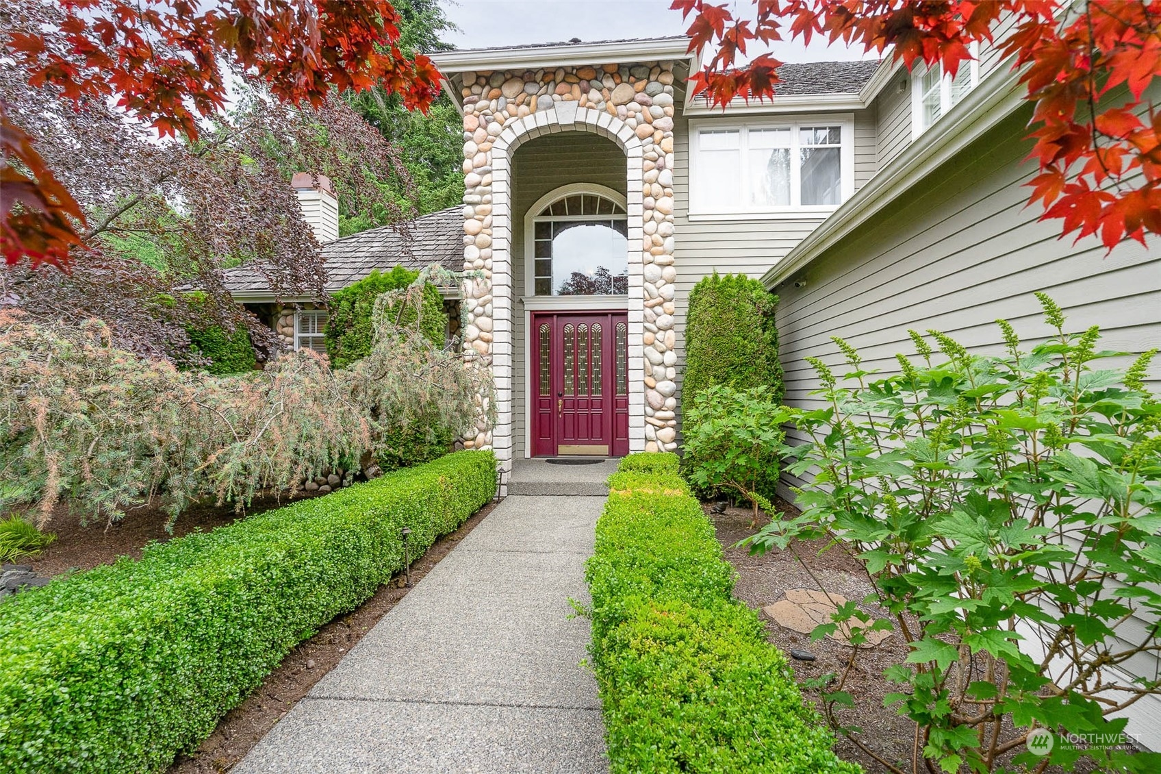 a front view of a house with a garden