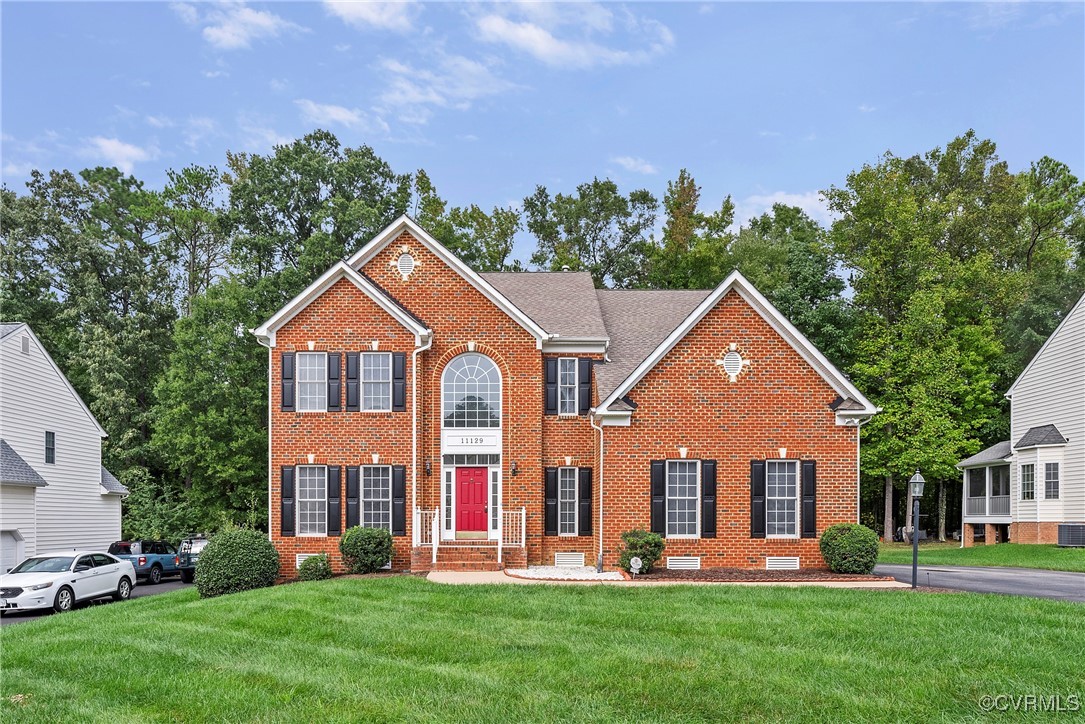 a front view of house with yard and green space