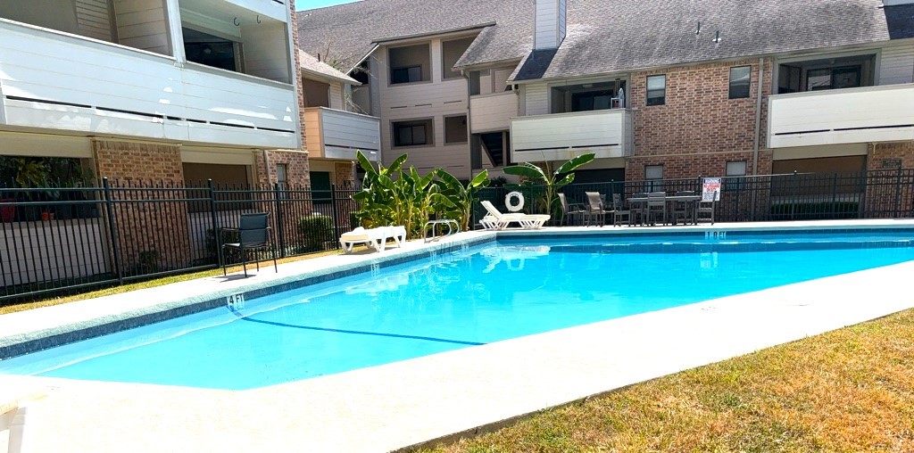 a swimming pool with outdoor seating