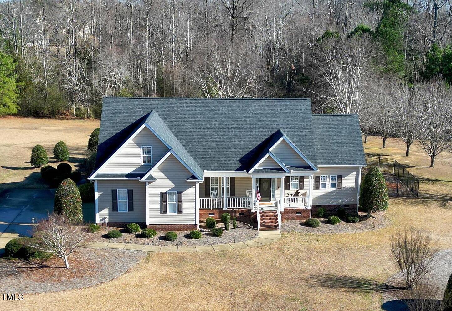 a front view of a house with a yard outdoor seating and garage