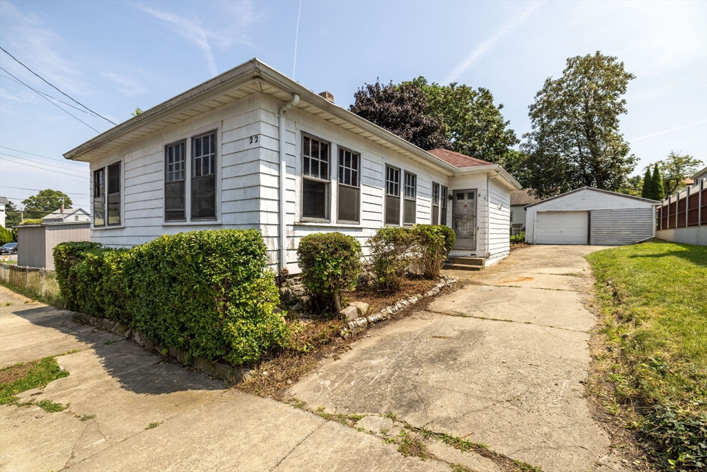 a front view of house with yard and trees around