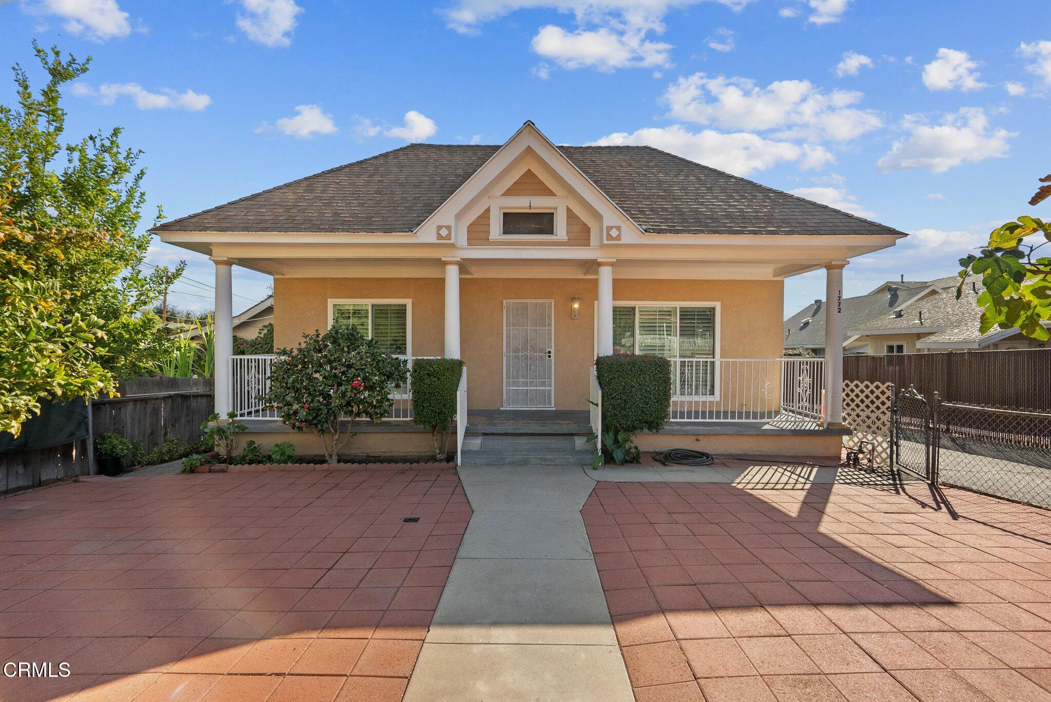 a front view of house with yard and seating space