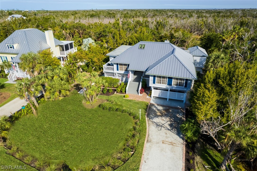 a aerial view of a house with a yard table and chairs