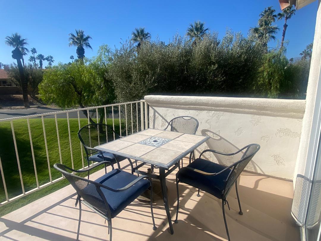 a view of a chairs and table on the deck