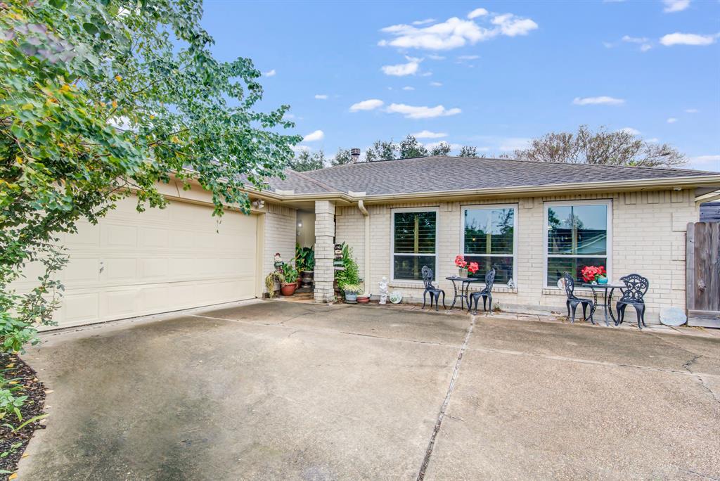 This charming home features a spacious driveway leading to a two-car garage. . Large windows provide plenty of natural light, enhancing the home's curb appeal.