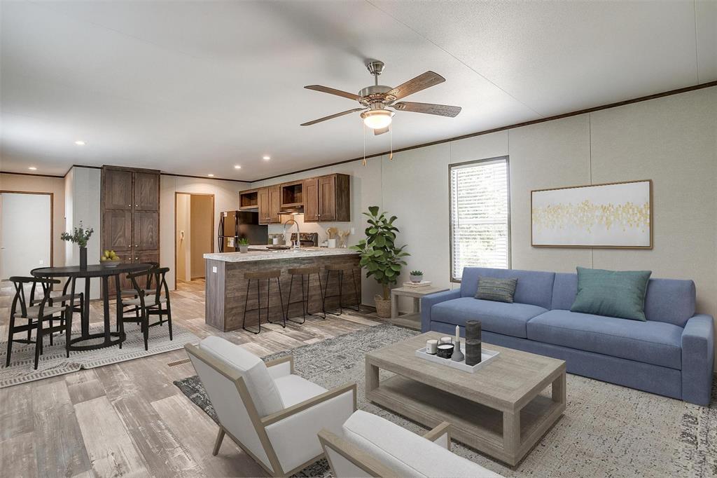 a living room with furniture a ceiling fan and a window