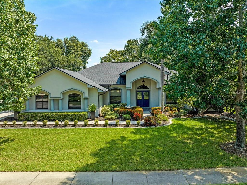 a front view of house with yard and green space