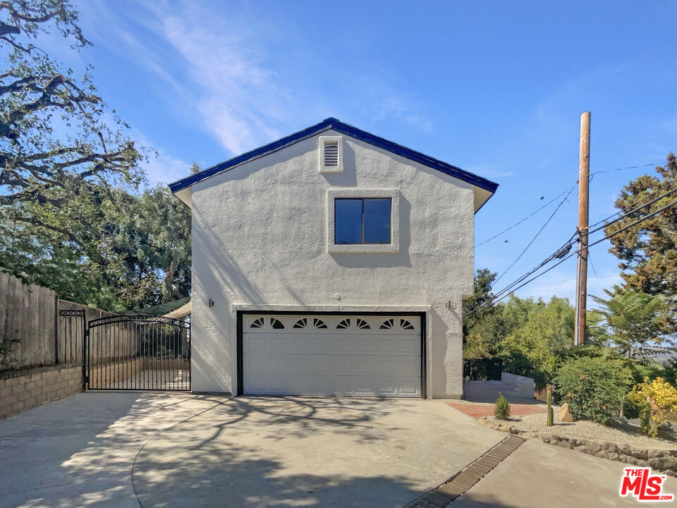 a front view of a house with garage