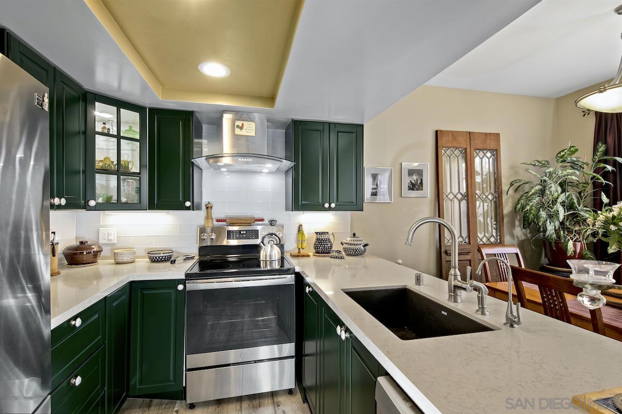 a kitchen with a sink cabinets and a stove