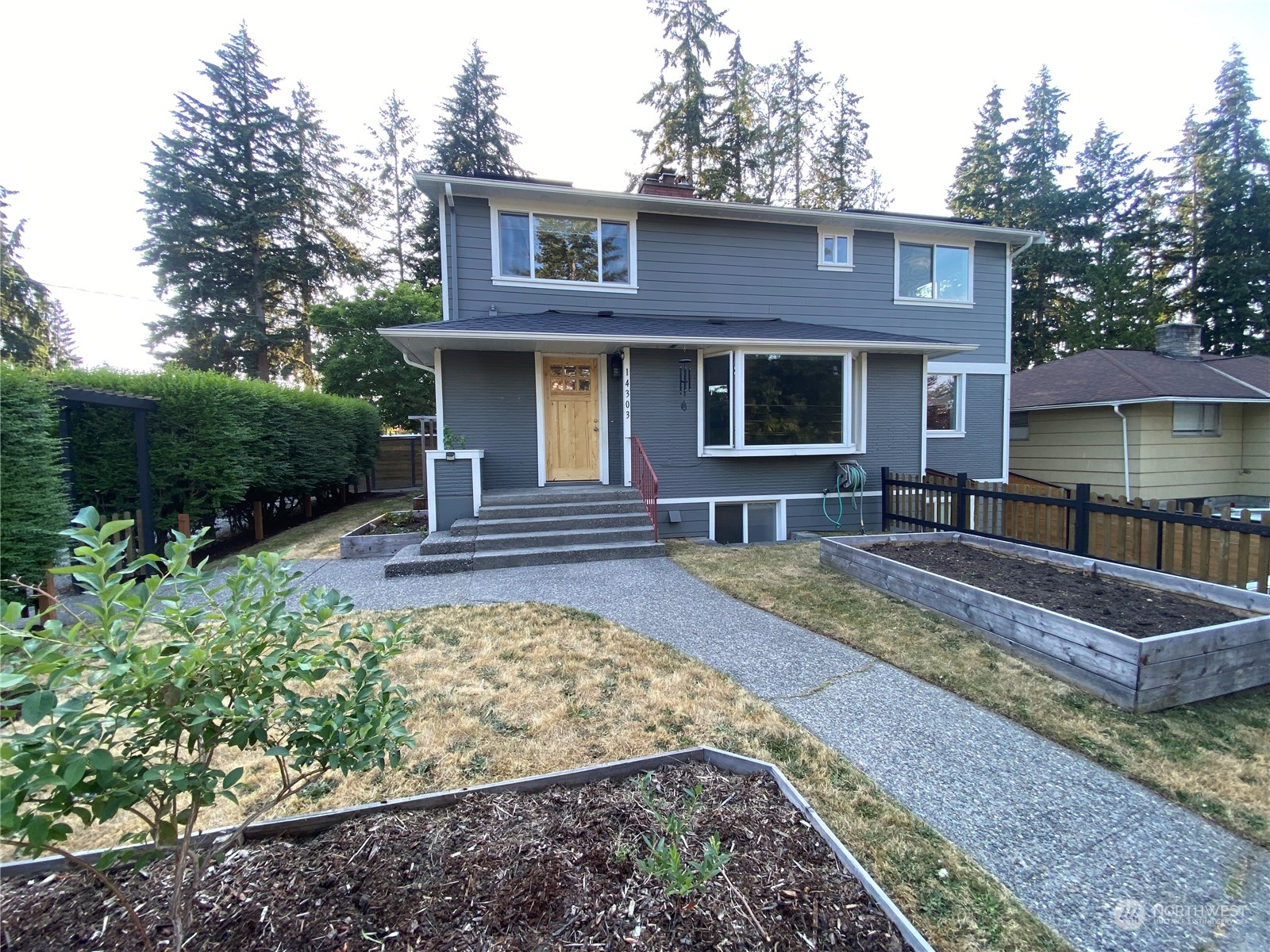 a front view of a house with garden