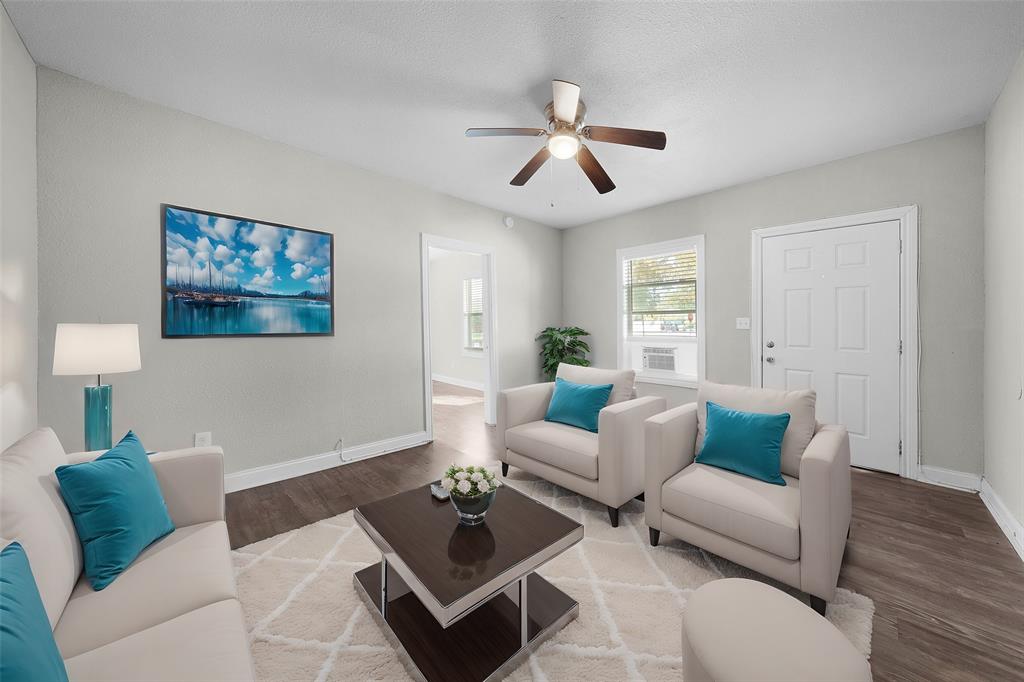 a living room with furniture and a wooden floor