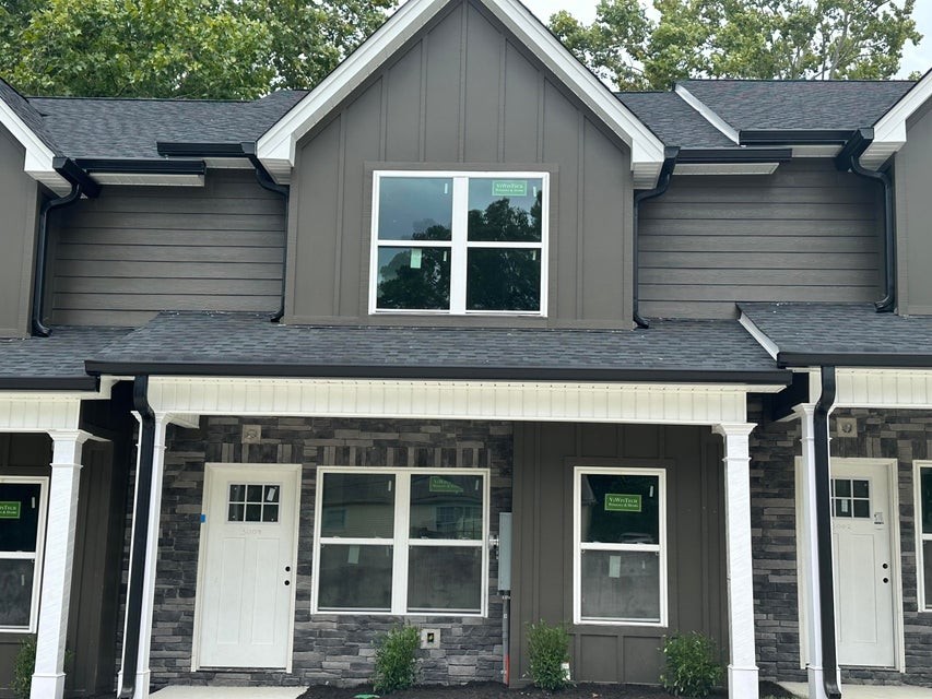 a view of a house with a yard and large window