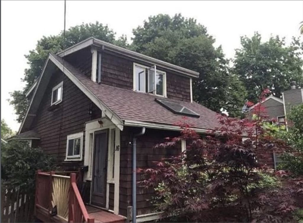 a front view of a house with garden