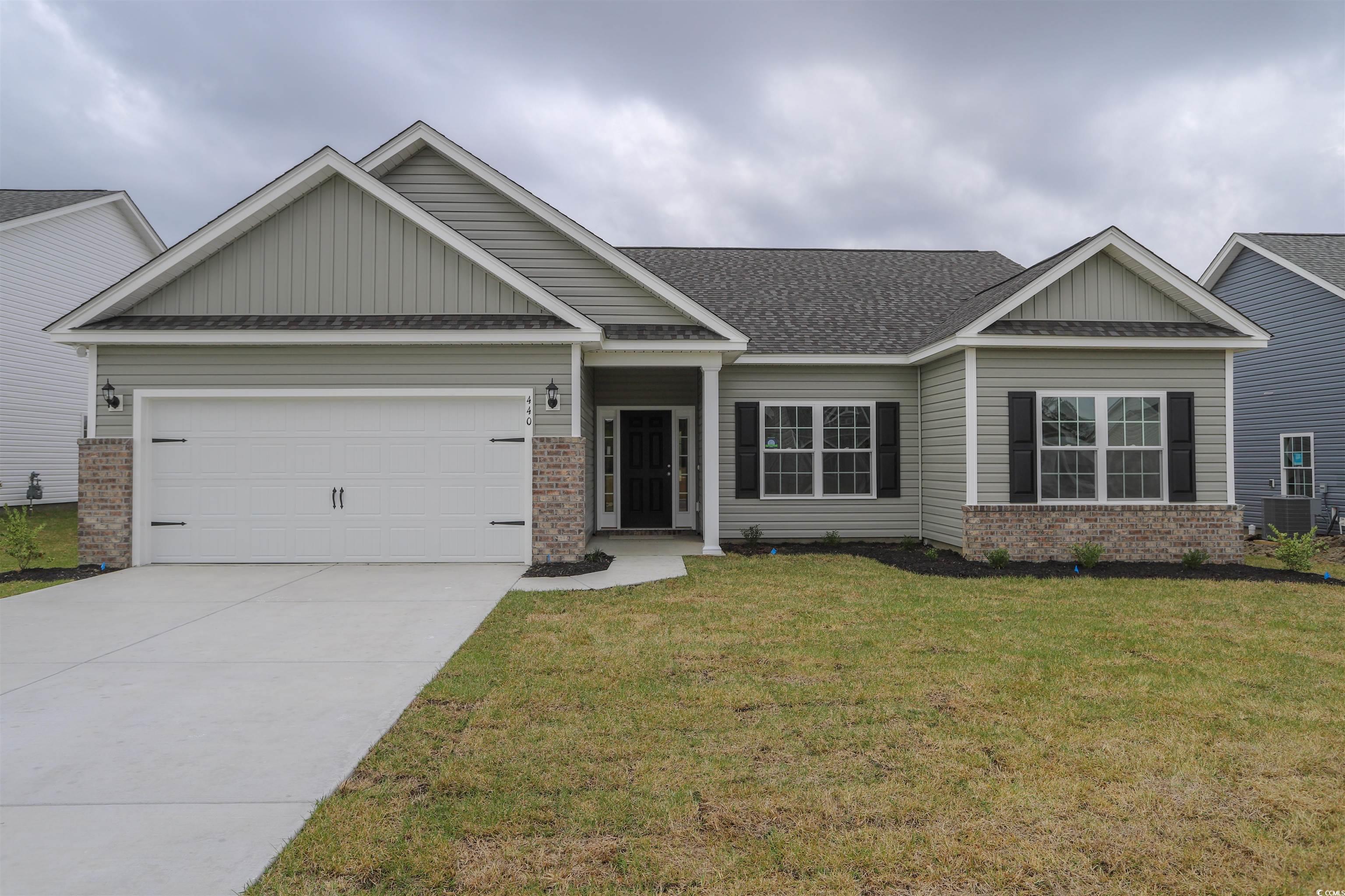 Craftsman-style house with a garage, central AC, a