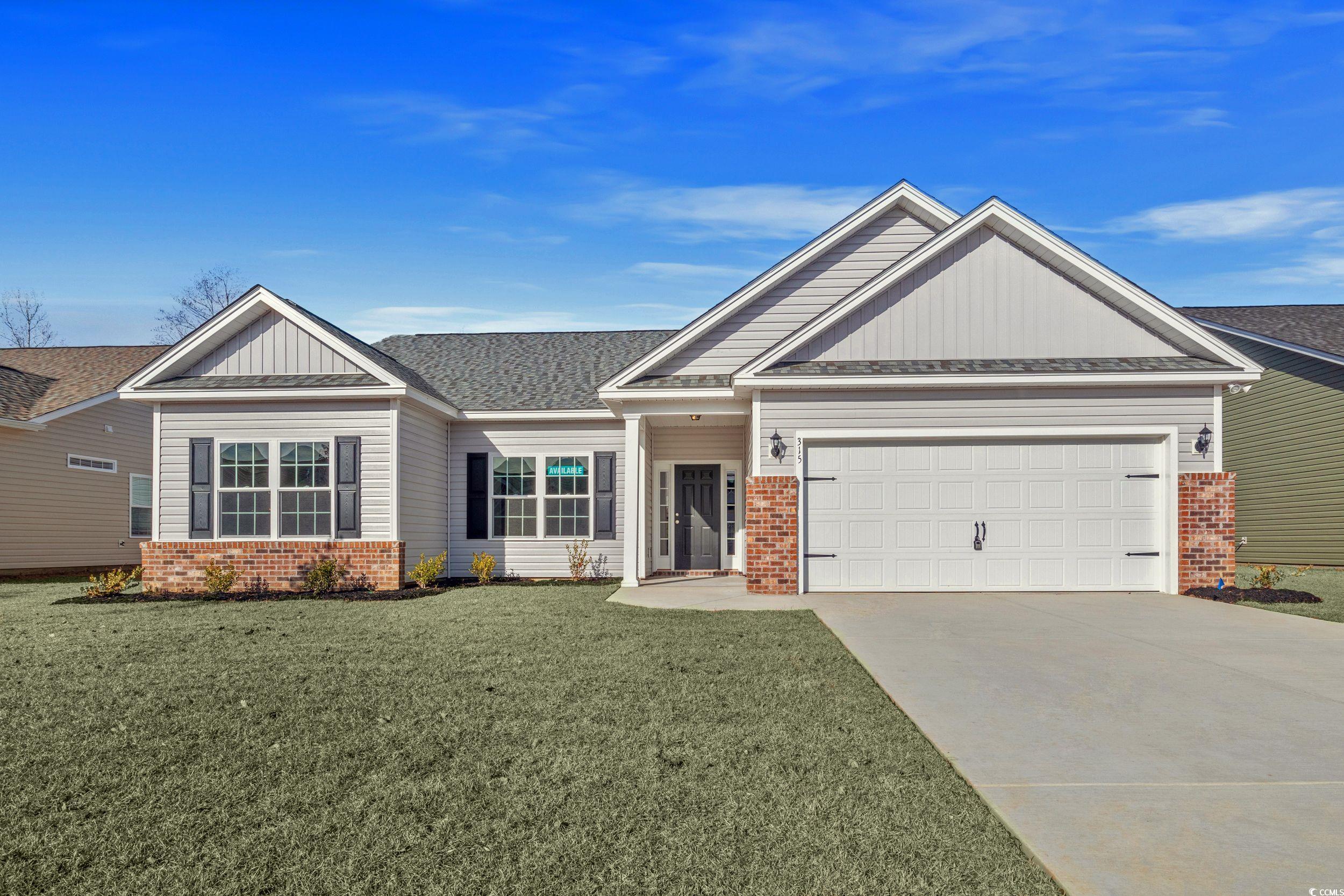 Craftsman house featuring a front lawn and a garag