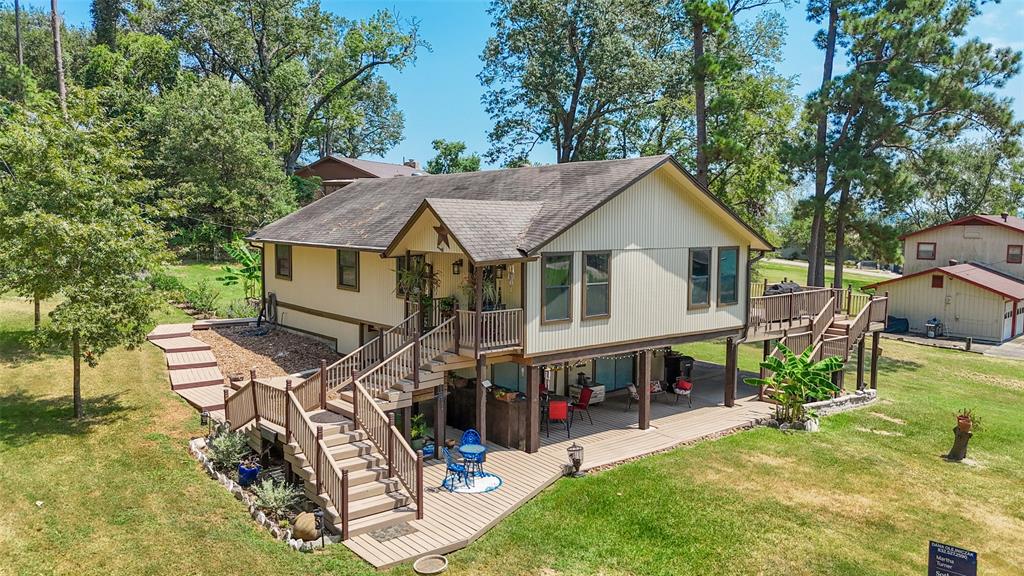 a view of a house with backyard porch and sitting area