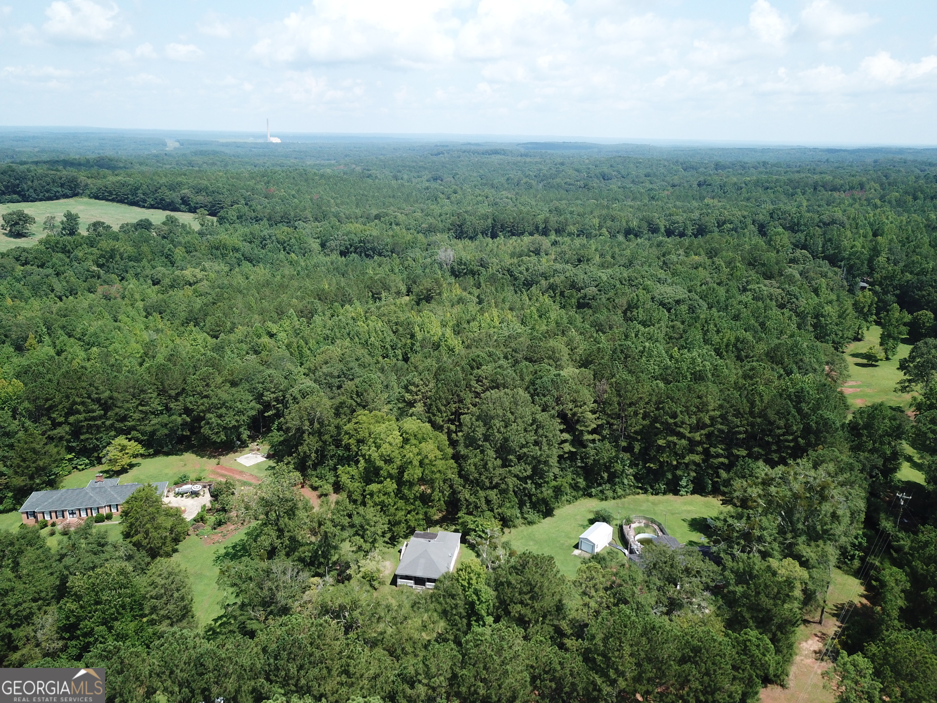 a view of a city with lush green forest