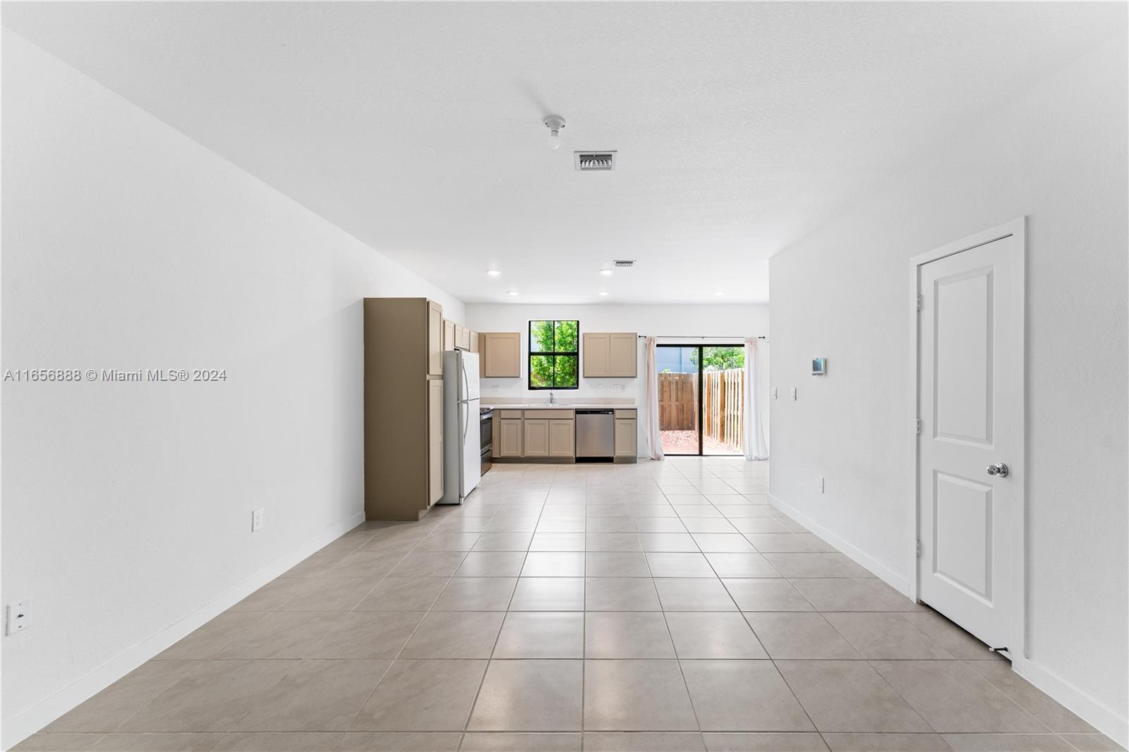 a view of a kitchen with furniture and an empty room