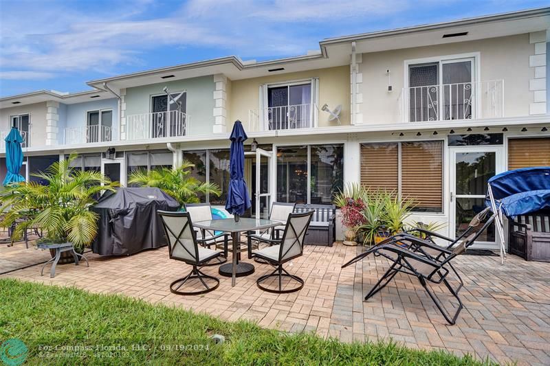 a view of a house with backyard and sitting area