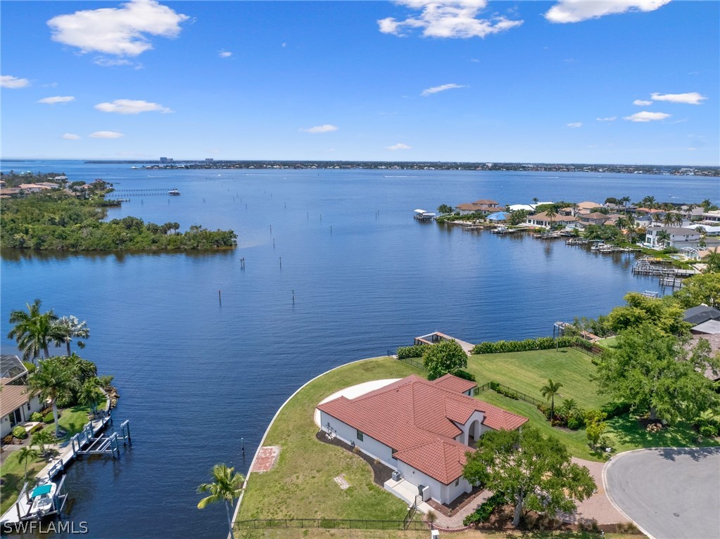 an aerial view of a house with a lake view