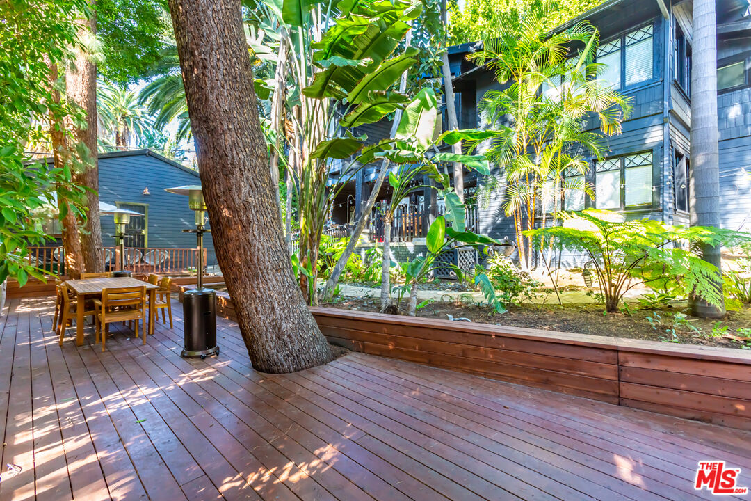 a wooden bench sitting in front of a building