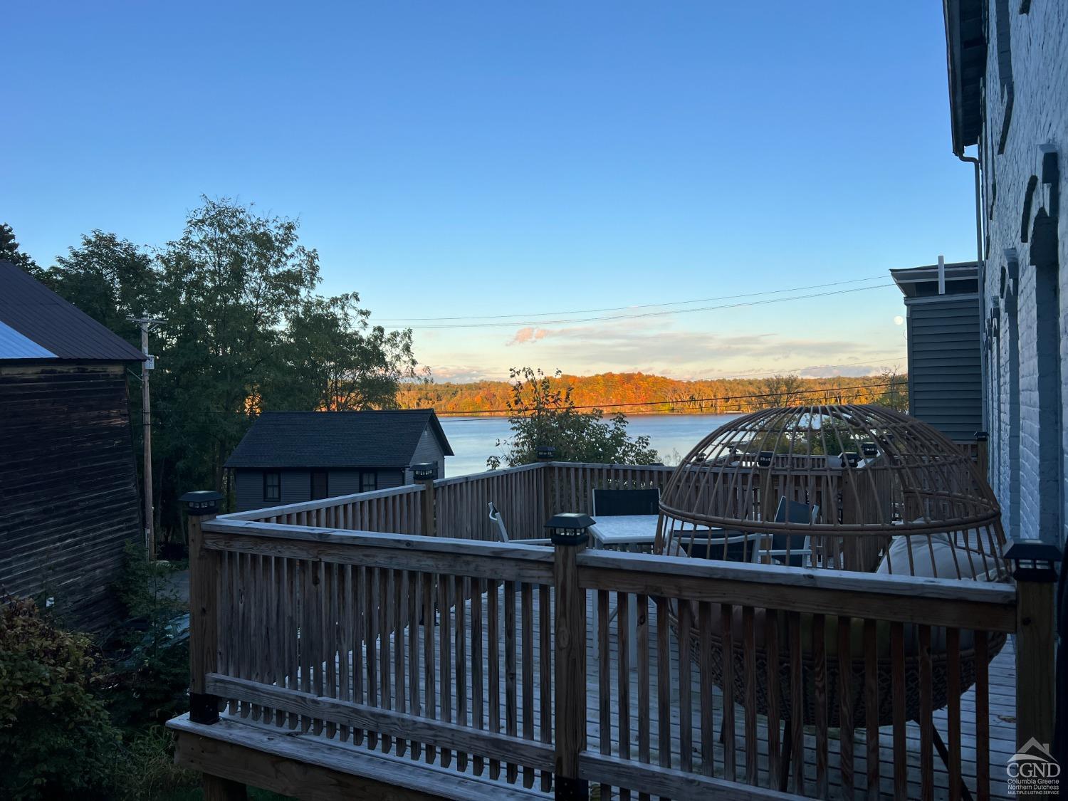 a view of a balcony with wooden floor and outdoor space