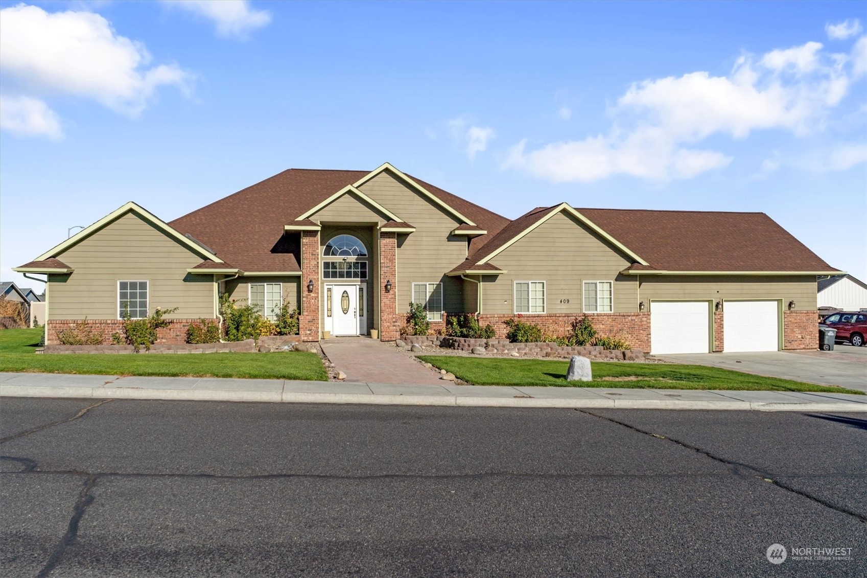 a front view of a house with a yard and porch