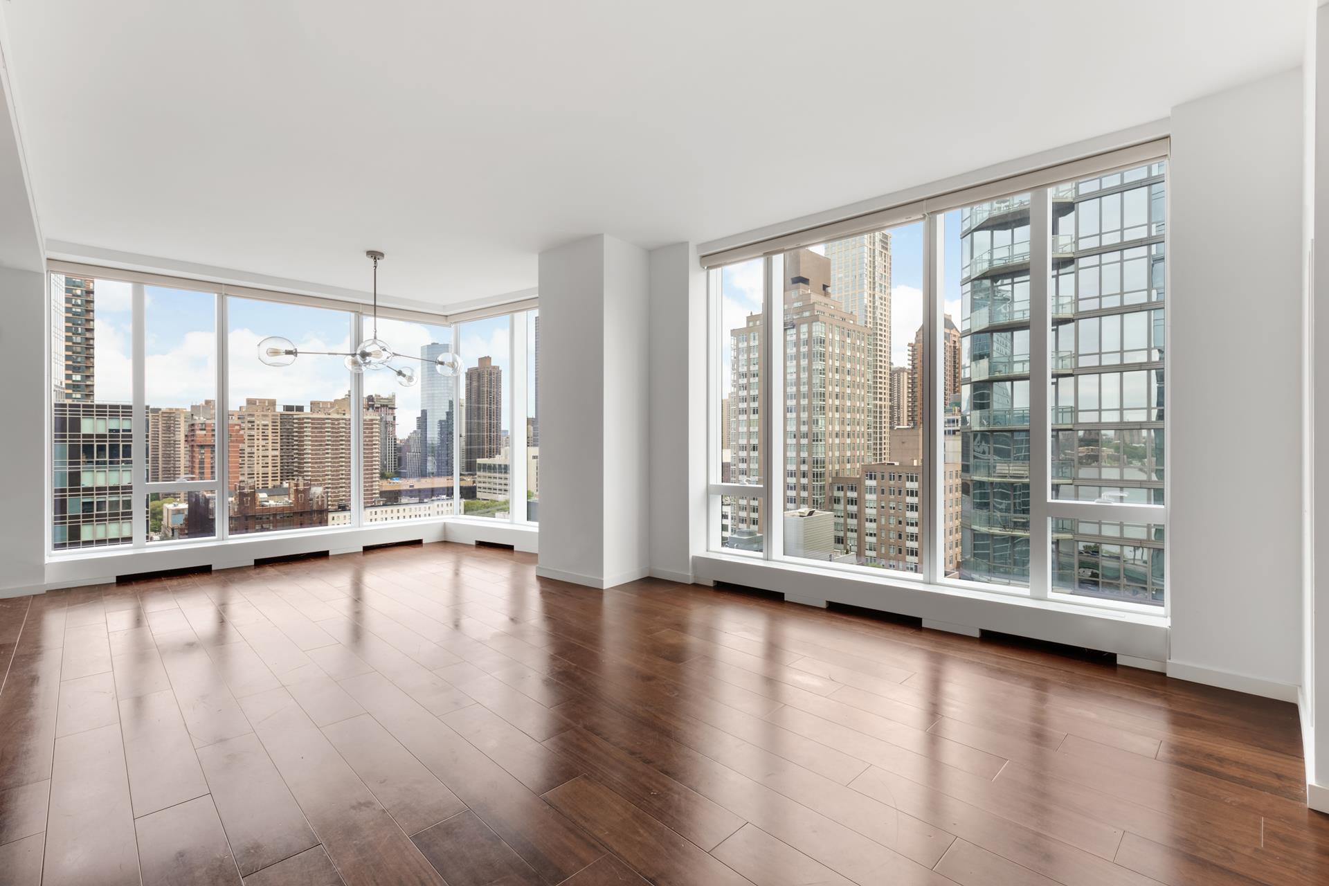 a view of room with wooden floor and floor to ceiling window