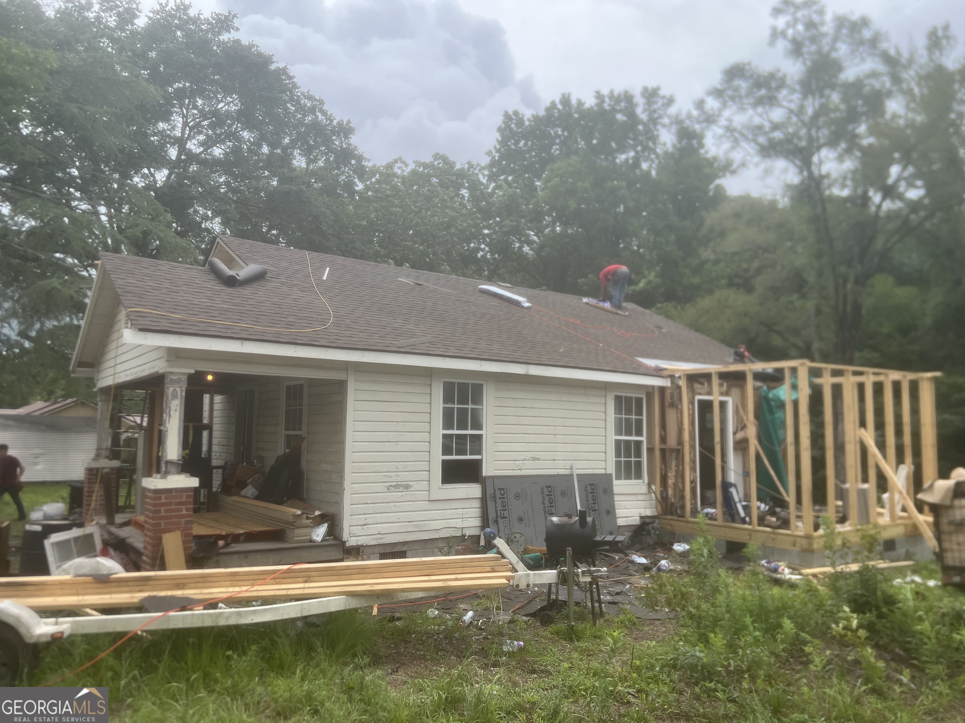 a view of a house with backyard porch and sitting area