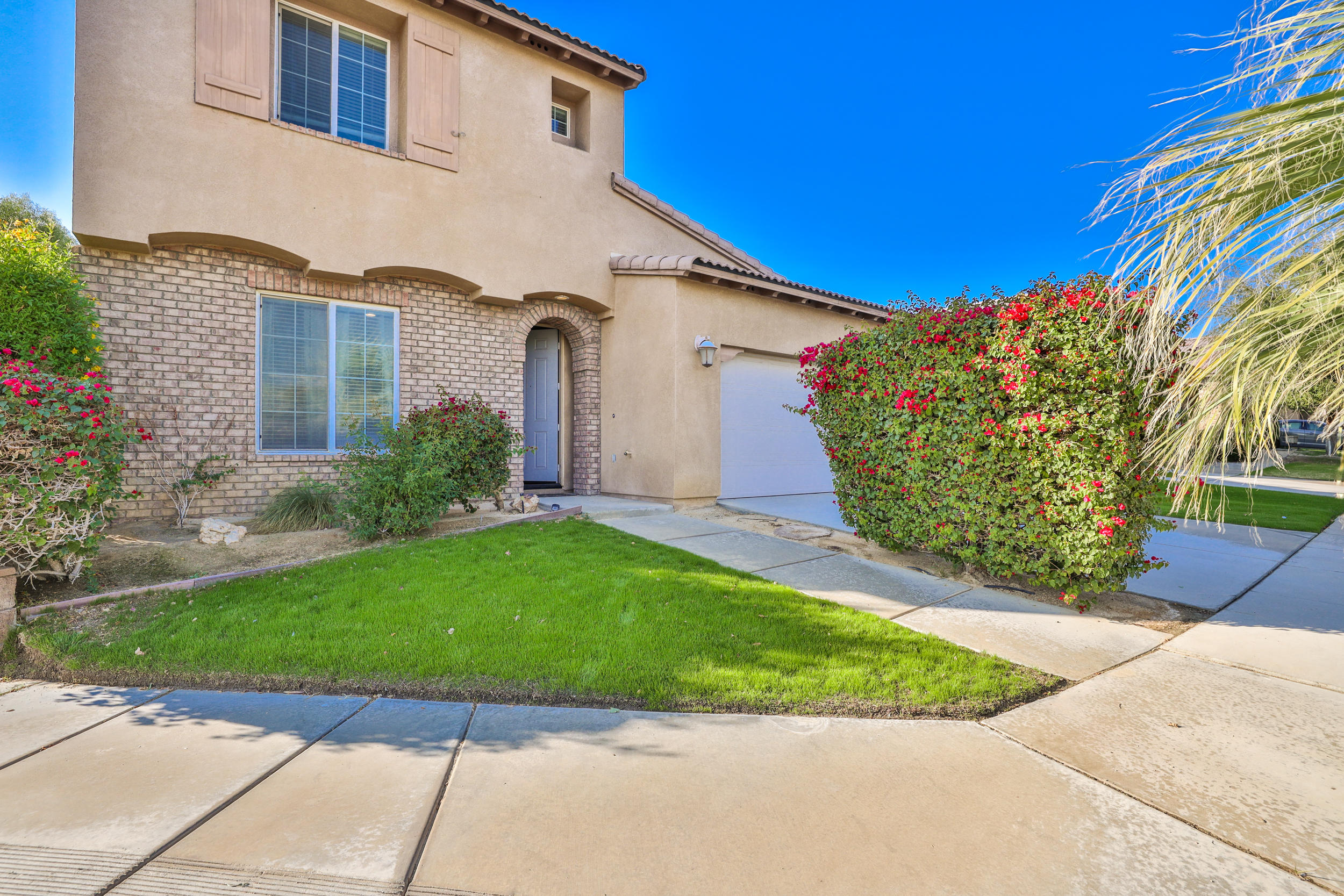 a front view of a house with a garden