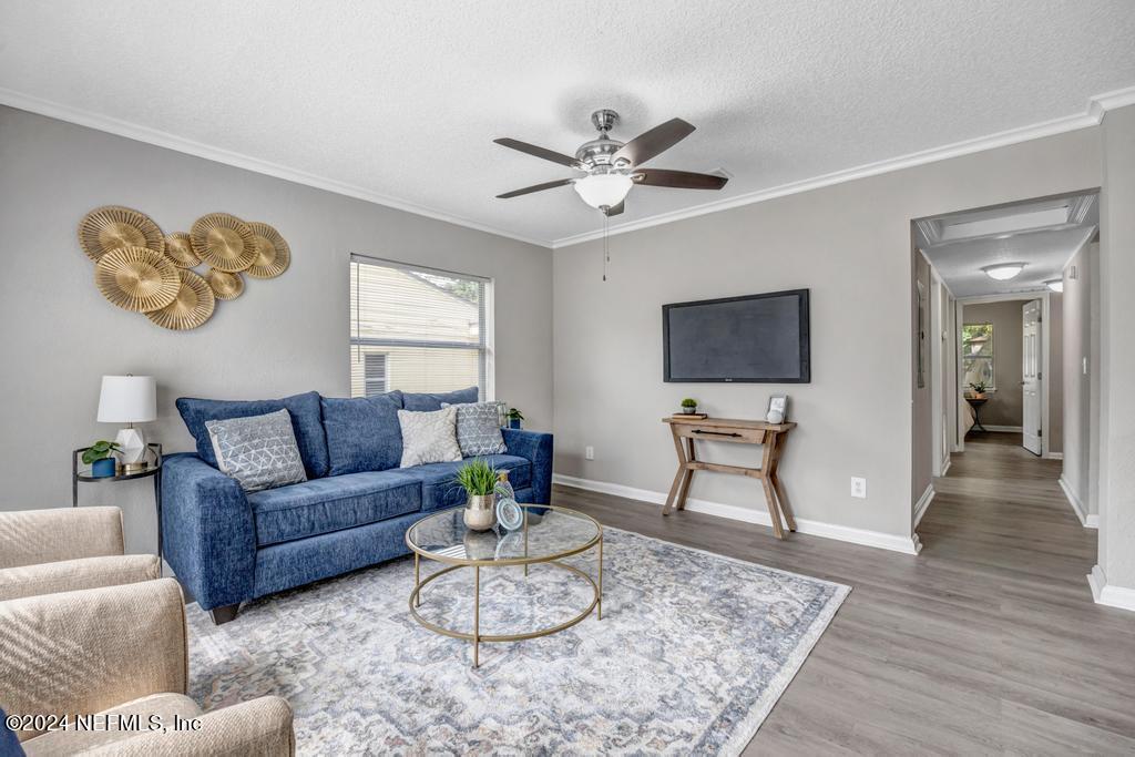 a living room with furniture and a flat screen tv