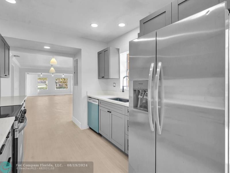 a kitchen with kitchen island a counter top space appliances and cabinets