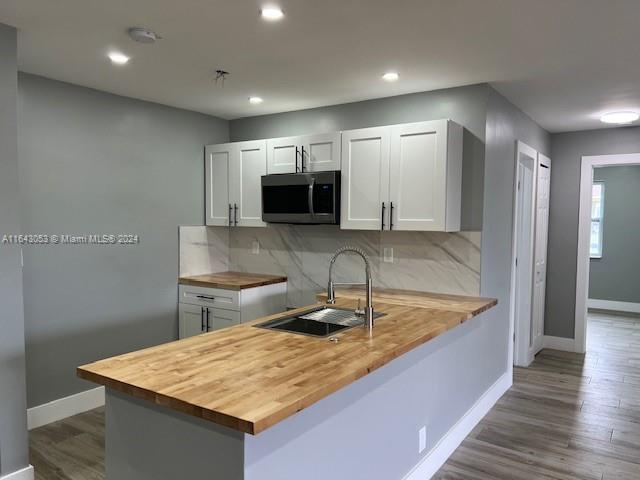 a kitchen with kitchen island sink and refrigerator