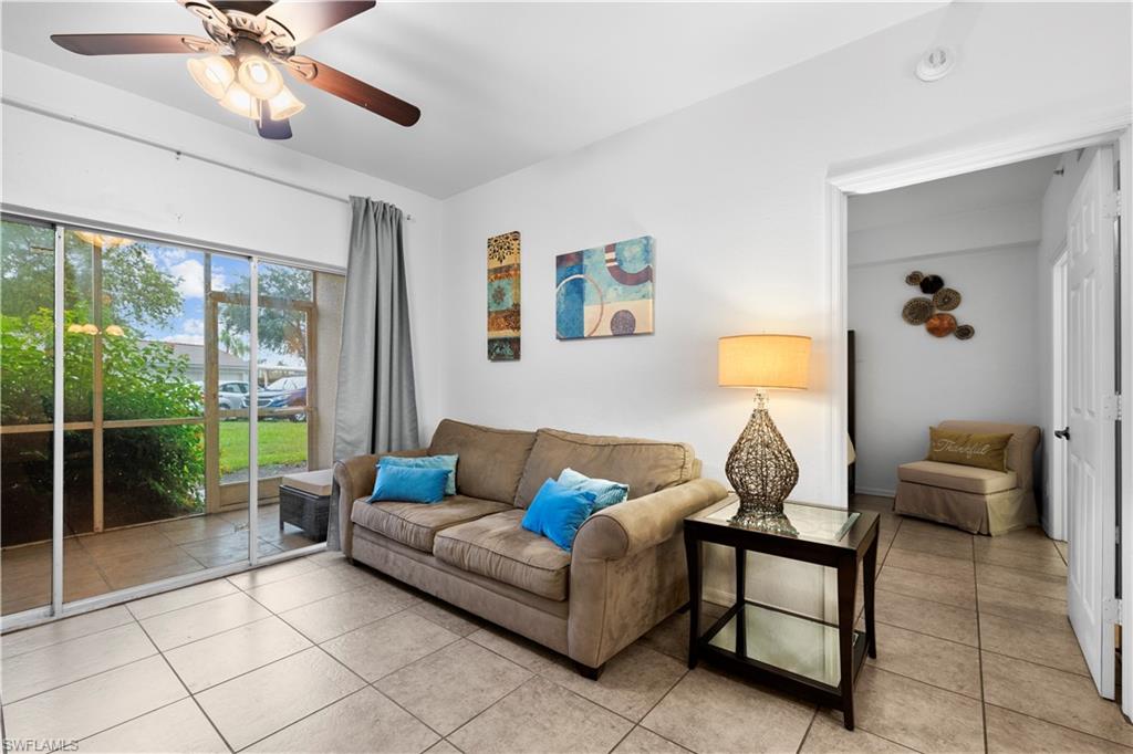 Tiled living room featuring ceiling fan