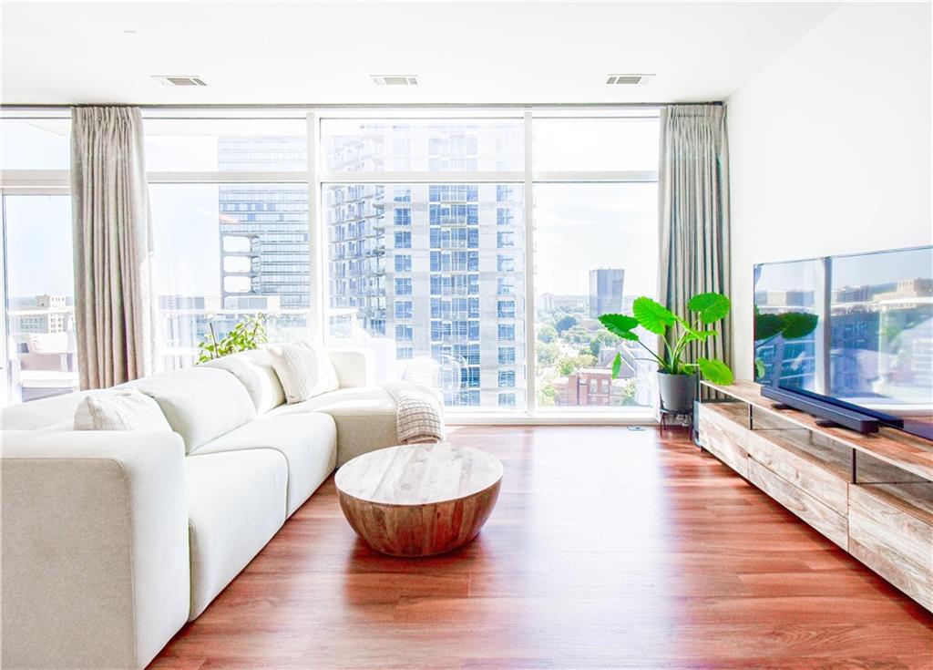 a living room with furniture and a potted plant