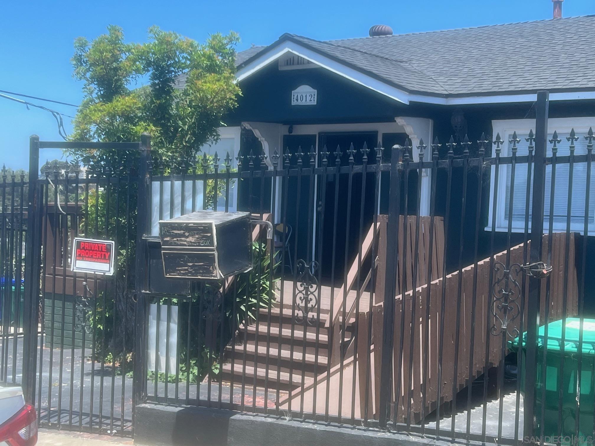 a view of a house with wooden fence